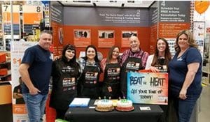 Alaskan team at booth at Home Depot receiving top service provider award 2018