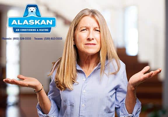 Woman holding hands up at sides looking confused with Alaskan Air Conditioning and Heating logo and contact phone numbers in top left corner